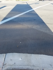 large rectangular shadow stretches into a road